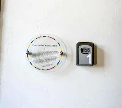 a clock on a wall with a plate on it at 22 Yedia North Nicosia Turkish Side in Nicosia