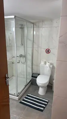 a bathroom with a toilet and a glass shower at Sun Shine Studio With Balcony in Larnaka