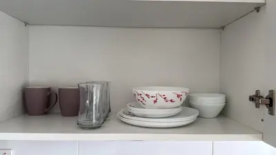 a shelf with plates and a vase on it at Sun Shine Studio With Balcony in Larnaka