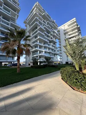 a sidewalk in front of two tall buildings at A peaceful apartment with sea views in Aglantzia
