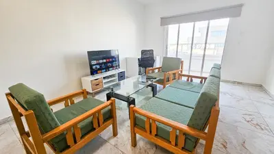 a living room with four chairs and a glass table at Central Rooms, 500m to Larnaca Marina in Larnaka