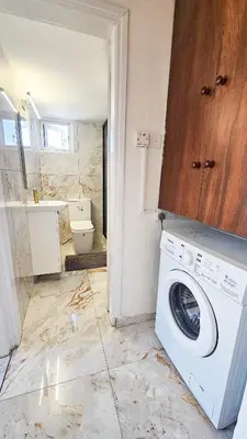 a washer and dryer in a bathroom with a toilet at Central Rooms, 500m to Larnaca Marina in Larnaka