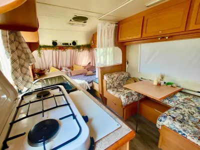 a kitchen and living room in an rv at Olive Grove Mountain Caravan in Limnatis