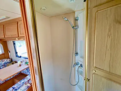 a bathroom with a shower in a caravan at Olive Grove Mountain Caravan in Limnatis