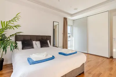 a bedroom with a large bed with two towels on it at Beachfront Luxury Apartment in Limassol