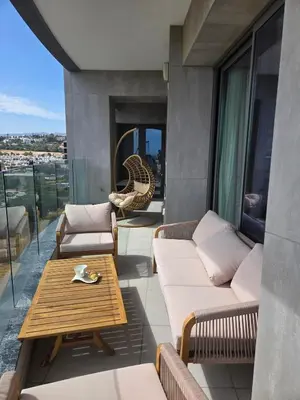 a patio with couches and a table on a balcony at Luxury Seaview Escape 3bd in Limassol Skyscraper in Limassol