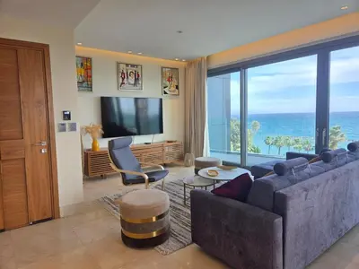 a living room with a couch and a large window at Luxury Seaview Escape 3bd in Limassol Skyscraper in Limassol