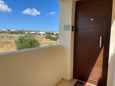 a door in a room with a view of a field at Nissi Beach sunny cozy apartment in Ayia Napa