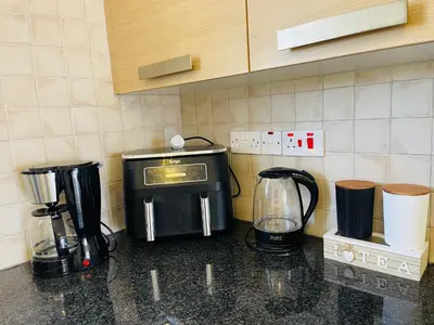 a kitchen counter with a coffee maker and a blender at Nissi Beach sunny cozy apartment in Ayia Napa