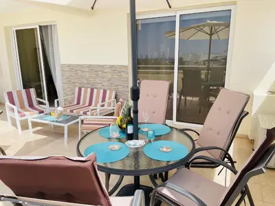 a dining room with a table and chairs at Nissi Beach sunny cozy apartment in Ayia Napa
