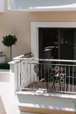 a balcony with a table and a chair at Pendeli Resort in Platres