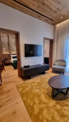 a living room with a large flat screen tv at Pendeli Resort in Platres