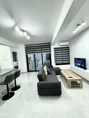 a living room with a couch and a table at Modern One-Bedroom Suite with Balcony in Central Nicosia in Nicosia