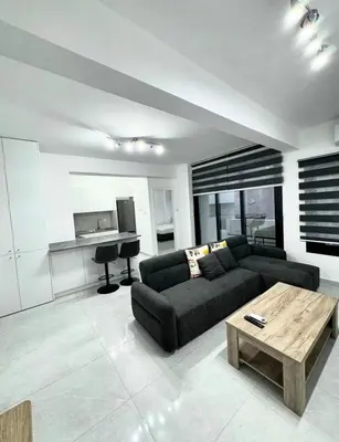 a living room with a couch and a table at Modern One-Bedroom Suite with Balcony in Central Nicosia in Nicosia