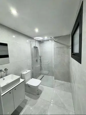 a bathroom with a shower and a toilet and a sink at Modern One-Bedroom Suite with Balcony in Central Nicosia in Nicosia