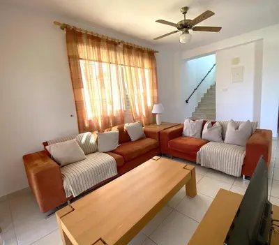 a living room with two couches and a table at Athena Holiday Villa DPS01 in Protaras
