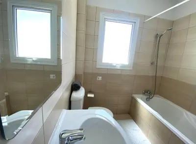 a bathroom with a sink and a tub and a toilet at Athena Holiday Villa DPS01 in Protaras