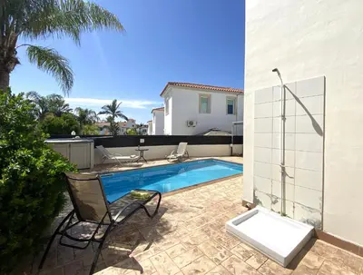 a backyard with a swimming pool and a house at Athena Holiday Villa DPS01 in Protaras