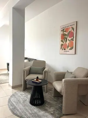 a living room with two chairs and a table at The Catherine in Larnaka