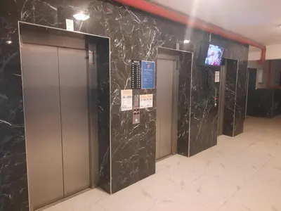 a row of elevators in a building with black marble walls at CAESAR RESORT İSKELE Long Beach in Vrysoules
