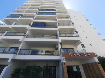 a tall white building with a marcus sign on it at CAESAR RESORT İSKELE Long Beach in Vrysoules