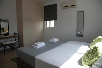 a bedroom with a bed with two towels on it at Pavilion Apt Cozy 2BR by Elysio in Paralimni