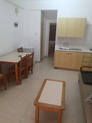 a kitchen with a table and a table and chairs at Sweet Memories STANDARD Apts in Protaras