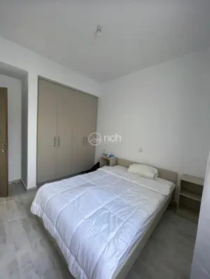 a white bedroom with a large bed in it at 1 bedroom apartment in egkomi makedontissa near unic in Strovolos