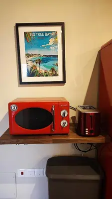 a red microwave sitting on top of a shelf at Boutique & Brand New Prime Location Park & Beach in Limassol