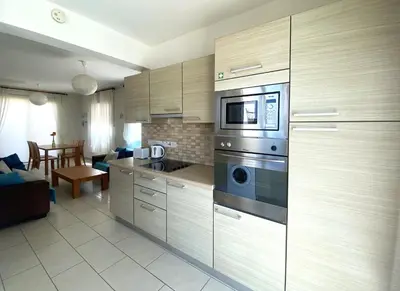 a kitchen with stainless steel appliances and a living room at Artemis Holiday Villa DPS09 with pool in Paralimni