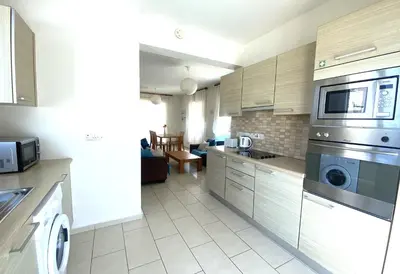 a kitchen with stainless steel appliances and a living room at Artemis Holiday Villa DPS09 with pool in Paralimni