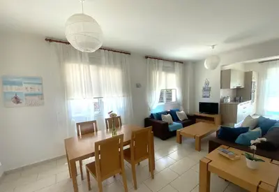 a living room with a couch and a table at Artemis Holiday Villa DPS09 with pool in Paralimni