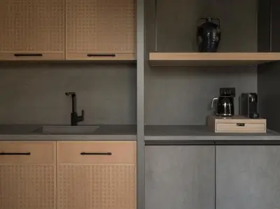 a kitchen with white cabinets and a sink at kolektif suites in Kérynia