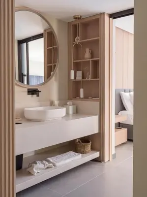 a bathroom with a sink and a mirror at kolektif suites in Kérynia