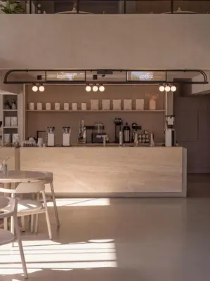 a kitchen with a counter and tables and chairs at kolektif suites in Kérynia