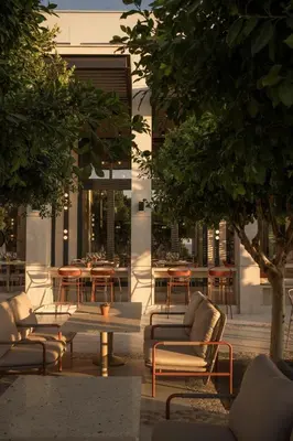 a patio with chairs and tables in a building at kolektif suites in Kérynia