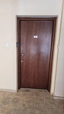 a wooden door in a room with a tile floor at Tersefanou Retreat Studio Apt in Tersephanou