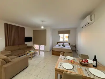 a living room with a couch and a bed at Tersefanou Retreat Studio Apt in Tersephanou