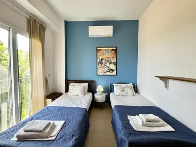 two beds in a room with blue walls at STAY Thalassa Villa in Paralimni