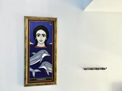a painting of a woman with dolphins on a wall at STAY Thalassa Villa in Paralimni