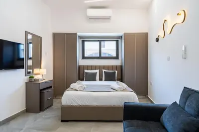 a bedroom with a bed and a couch at Le Bandit Studio in Larnaka