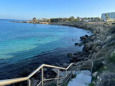 a staircase leading down to a body of water at Tsokkos Protaras Beach Hotel in Protaras