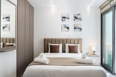 a bedroom with a large bed with towels on it at Starlight Studio in Larnaka