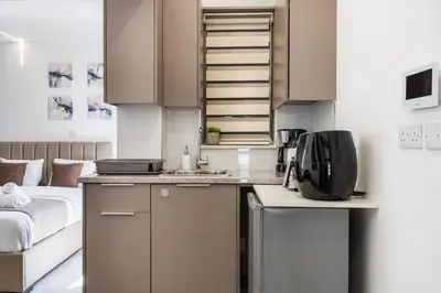a small kitchen with a bed in a room at Starlight Studio in Larnaka