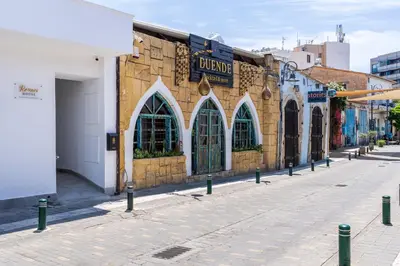 a street with a building with arched windows on it at Starlight Studio in Larnaka