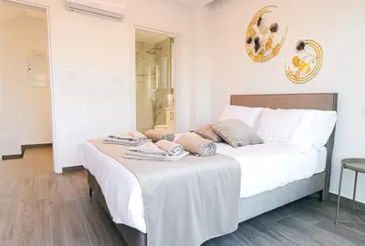 a bedroom with a bed with towels on it at Nissinest Luxury Villas in Ayia Napa