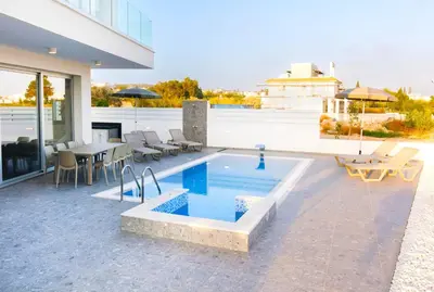a swimming pool on the patio of a house at Nissinest Luxury Villas in Ayia Napa
