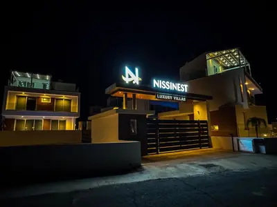 a building with a sign on it at night at Nissinest Luxury Villas in Ayia Napa