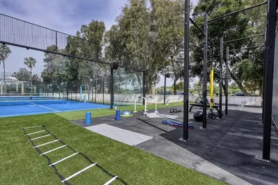 a tennis court with a batting cage and a tennis court at Dome Beach Marina Hotel & Resort in Ayia Napa