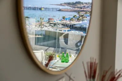 a mirror reflection of a table with a view of a harbor at Constantinos the Great Beach Hotel in Protaras